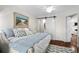 Comfortable bedroom featuring a large art piece and rustic sliding door leading to bathroom at 4999 Highway 17 Business # 302, Murrells Inlet, SC 29576