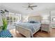 Spacious bedroom with hardwood floors, ceiling fan, and natural light from the patio access at 4999 Highway 17 Business # 302, Murrells Inlet, SC 29576