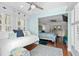 Bedroom with white trundle bed, ceiling fan, and bright lighting overlooking Primary bedroom at 4999 Highway 17 Business # 302, Murrells Inlet, SC 29576