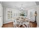 Cozy dining room with a charming chandelier, plantation shutters, and stylish decor at 4999 Highway 17 Business # 302, Murrells Inlet, SC 29576