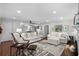 Open-concept living room with hardwood floors, stylish furniture, and abundant natural light at 4999 Highway 17 Business # 302, Murrells Inlet, SC 29576