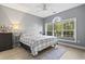 Bright bedroom with a ceiling fan and large arched window overlooking a lush backyard at 5750 Oyster Catcher Dr. # 714, North Myrtle Beach, SC 29582