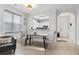 Dining area featuring a modern table set, gray upholstered chairs, and a view into the kitchen at 5750 Oyster Catcher Dr. # 714, North Myrtle Beach, SC 29582
