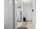 Hallway view leading to kitchen with stainless steel appliances, white walls, and neutral flooring at 5750 Oyster Catcher Dr. # 714, North Myrtle Beach, SC 29582