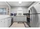 Well-lit kitchen with stainless steel appliances, white cabinetry, mosaic backsplash, and plenty of counter space at 5750 Oyster Catcher Dr. # 714, North Myrtle Beach, SC 29582