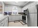 Bright kitchen featuring white cabinets, stainless steel appliances, and a window above the sink at 5750 Oyster Catcher Dr. # 714, North Myrtle Beach, SC 29582