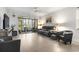 Bright living room featuring a gray sofa, plush chair, and large windows offering a view of the outdoors at 5750 Oyster Catcher Dr. # 714, North Myrtle Beach, SC 29582