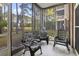 Screened-in porch featuring outdoor seating with a view of the landscaped lawn and trees at 5750 Oyster Catcher Dr. # 714, North Myrtle Beach, SC 29582
