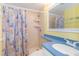Bright bathroom with a shower, seashell-themed shower curtain, and stylish vanity with ample lighting at 5905 S Kings Hwy. # 1612, Myrtle Beach, SC 29575