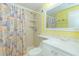Bright bathroom featuring a shower, vanity with lighting, and seashell themed decorations throughout at 5905 S Kings Hwy. # 1612, Myrtle Beach, SC 29575