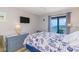 Bright bedroom featuring a queen bed with a nautical-themed comforter and a balcony overlooking the ocean at 5905 S Kings Hwy. # 1612, Myrtle Beach, SC 29575