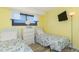 Inviting bedroom with two beds featuring seashell bedding, a dresser, and a window with natural light at 5905 S Kings Hwy. # 1612, Myrtle Beach, SC 29575