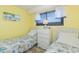 Inviting bedroom with two beds featuring seashell bedding, a dresser, and a window with natural light at 5905 S Kings Hwy. # 1612, Myrtle Beach, SC 29575