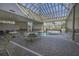 A bright indoor pool area with a glass roof offers plenty of seating at 5905 S Kings Hwy. # 1612, Myrtle Beach, SC 29575