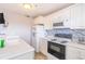 Bright kitchen featuring white cabinets, modern appliances, and tiled backsplash at 5905 S Kings Hwy. # 1612, Myrtle Beach, SC 29575