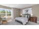Bedroom with neutral walls, comfortable chair, a bed with patterned bedding and two matching nightstands at 615 Forage Dr, Conway, SC 29526