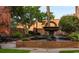 A relaxing outdoor scene with a gorgeous brick fountain surrounded by lush landscaping at 615 Forage Dr, Conway, SC 29526