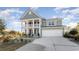 Charming two-story home boasts a double porch, attached garage, and beautifully landscaped front yard at 615 Forage Dr, Conway, SC 29526