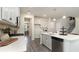Stylish kitchen with stainless steel appliances, white cabinets and island plus adjacent staircase at 615 Forage Dr, Conway, SC 29526