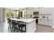 Well-lit kitchen with island seating, stainless appliances, white cabinetry and an adjacent dining area at 615 Forage Dr, Conway, SC 29526