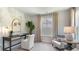 Home office boasts stylish desk and seating area, light walls, large windows with neutral curtains at 615 Forage Dr, Conway, SC 29526