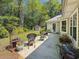 Private backyard featuring a patio with seating, complemented by mature trees and a storage shed at 64 Reef Run Rd., Pawleys Island, SC 29585