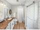 Renovated bathroom features vanity with granite counters, and a modern glass shower at 64 Reef Run Rd., Pawleys Island, SC 29585