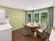 Cozy breakfast nook is surrounded by windows, offering an abundance of natural light at 64 Reef Run Rd., Pawleys Island, SC 29585