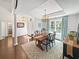 Charming dining room with hardwood floors, chandelier, and stylish decor at 64 Reef Run Rd., Pawleys Island, SC 29585