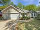 Attractive home featuring a two-car garage and a well-manicured lawn with beautiful landscaping at 64 Reef Run Rd., Pawleys Island, SC 29585