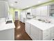 Contemporary kitchen boasts white cabinets, stainless appliances, subway tile, and quartz countertops at 64 Reef Run Rd., Pawleys Island, SC 29585