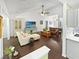 Bright living room features vaulted ceilings, ceiling fan, hardwood floors, and comfortable seating at 64 Reef Run Rd., Pawleys Island, SC 29585