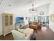 Bright living room features vaulted ceilings, ceiling fan, hardwood floors, and comfortable seating at 64 Reef Run Rd., Pawleys Island, SC 29585