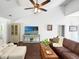 Cozy living room features vaulted ceilings, ceiling fan, hardwood floors, and comfortable seating at 64 Reef Run Rd., Pawleys Island, SC 29585