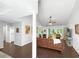 Bright, open-concept living room with hardwood floors and large windows offering ample natural light at 64 Reef Run Rd., Pawleys Island, SC 29585