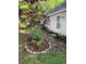 Backyard garden area with stone-lined flowerbed and natural stone path at 64 Reef Run Rd., Pawleys Island, SC 29585