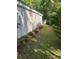 Side yard view featuring a well-maintained lawn, landscaping, and shed at 64 Reef Run Rd., Pawleys Island, SC 29585