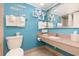 Light blue bathroom with white towels, granite vanity, and decorative beach themed decor at 7100 N Ocean Blvd. N # 912, Myrtle Beach, SC 29572