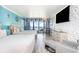 Bright bedroom featuring two queen beds, balcony access, a dining area and a flat screen television at 7100 N Ocean Blvd. N # 912, Myrtle Beach, SC 29572