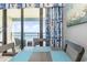 Cozy dining area with ocean view, balcony access, and beach-themed decor at 7100 N Ocean Blvd. N # 912, Myrtle Beach, SC 29572