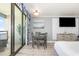 Inviting living space with a dining table, ocean view, and mounted TV at 7100 N Ocean Blvd. N # 912, Myrtle Beach, SC 29572