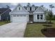 Charming home featuring a pristine two-car garage, fresh landscaping, and stylish architectural details at 712 Lapwind Loop, Myrtle Beach, SC 29579