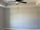 Cozy bedroom with a modern ceiling fan, tray ceiling, and neutral paint, perfect for relaxation at 8050 Mill Pond Rd., Galivants Ferry, SC 29544