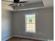 Comfortable bedroom with tray ceiling, ceiling fan, and a window offering pleasant natural light at 8050 Mill Pond Rd., Galivants Ferry, SC 29544