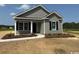Charming single-story home featuring gray siding, a covered entryway, and well-manicured landscaping at 8050 Mill Pond Rd., Galivants Ferry, SC 29544