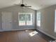 Inviting living room with a modern ceiling fan, lots of natural light, and a door to an outdoor space at 8050 Mill Pond Rd., Galivants Ferry, SC 29544
