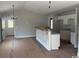 Open-concept kitchen featuring an island with granite countertops and white cabinetry at 8054 Mill Pond Rd., Galivants Ferry, SC 29544
