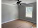 Bright bedroom featuring a ceiling fan, a window with blinds, and neutral walls at 8062 Mill Pond Rd., Galivants Ferry, SC 29544