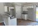 Cozy kitchen with white cabinets, granite countertops, and a breakfast bar, offering a modern and inviting space at 8062 Mill Pond Rd., Galivants Ferry, SC 29544