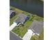 Aerial view showcases the home's backyard bordering a pond, surrounded by lush landscaping and neighboring houses at 897 Wild Leaf Loop, Conway, SC 29526